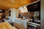 Discover the charm of this cozy kitchen, featuring a modern design with sleek cabinetry and a stainless steel oven.