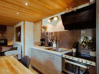 Discover the charm of this cozy kitchen, featuring a modern design with sleek cabinetry and a stainless steel oven.