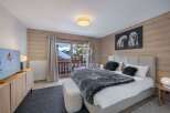 Experience luxury in this stunning bedroom with a cozy ambiance.