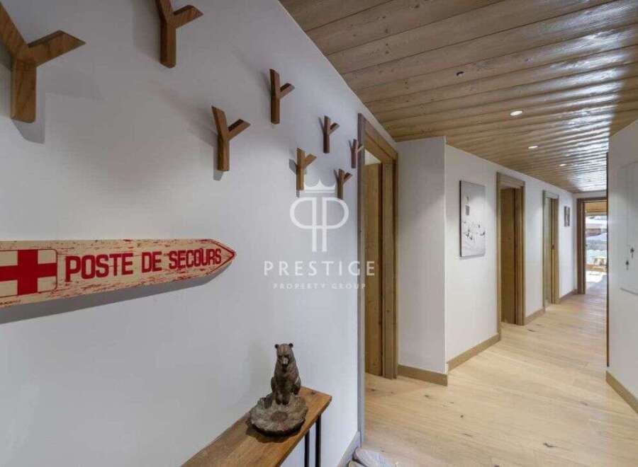 Discover the charm of this stunning property, featuring a beautifully designed hallway with wooden accents and a warm, inviting atmosphere.
