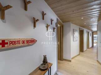 Discover the charm of this stunning property, featuring a beautifully designed hallway with wooden accents and a warm, inviting atmosphere.