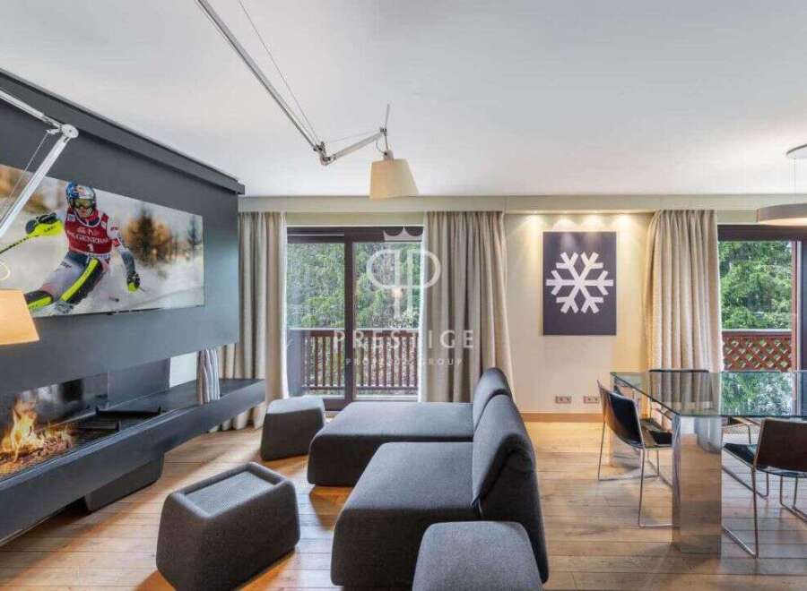 Experience luxury living in this stunning property, featuring a modern fireplace and a sleek, contemporary design.