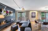 Experience luxury living in this stunning property, featuring a modern fireplace and a sleek, contemporary design.