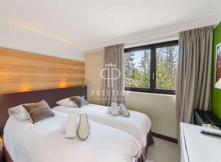 Discover a cozy bedroom with two comfortable beds, perfect for a relaxing stay.
