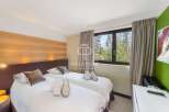 Discover a cozy bedroom with two comfortable beds, perfect for a relaxing stay.