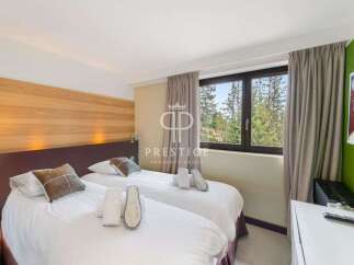 Discover a cozy bedroom with two comfortable beds, perfect for a relaxing stay.