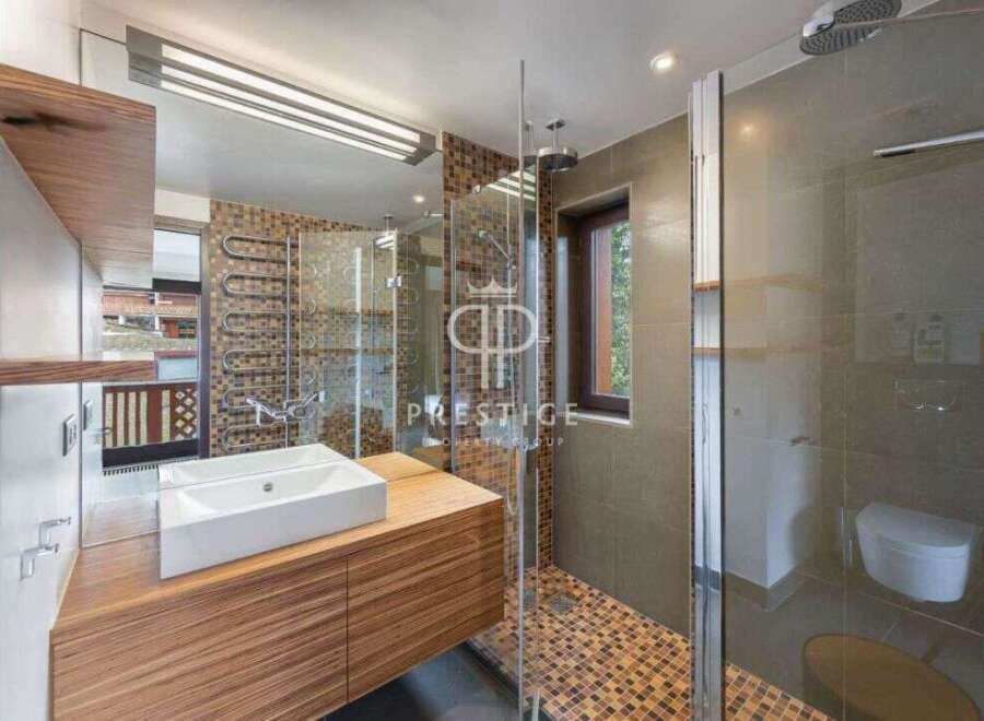 Discover luxury living in this stunning property! The modern bathroom boasts a sleek design with a spacious shower and elegant fixtures.