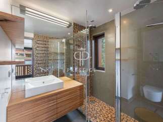 Discover luxury living in this stunning property! The modern bathroom boasts a sleek design with a spacious shower and elegant fixtures.