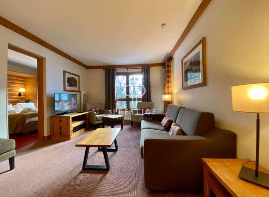 Discover a cozy living space with a comfortable sofa and inviting ambiance.