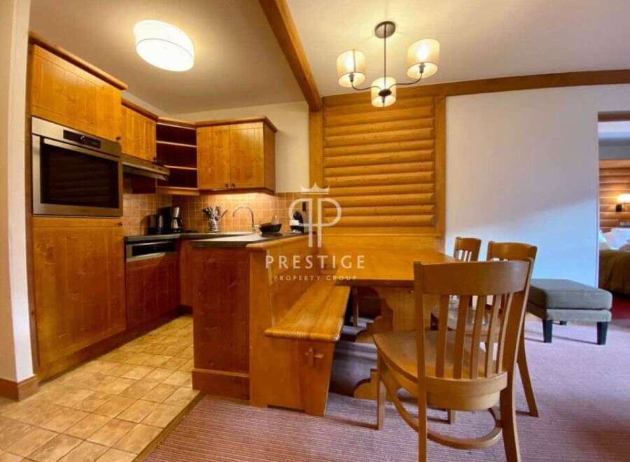 Discover the charm of this property, featuring a cozy kitchen with wooden cabinetry and modern appliances.