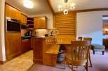 Discover the charm of this property, featuring a cozy kitchen with wooden cabinetry and modern appliances.