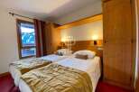 Cozy bedroom featuring two comfortable beds, perfect for a relaxing stay.