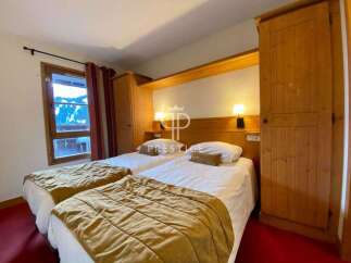 Cozy bedroom featuring two comfortable beds, perfect for a relaxing stay.