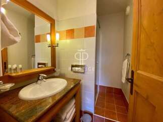 Discover a luxurious bathroom featuring a stylish vanity with a sleek sink and a stunning mirror.