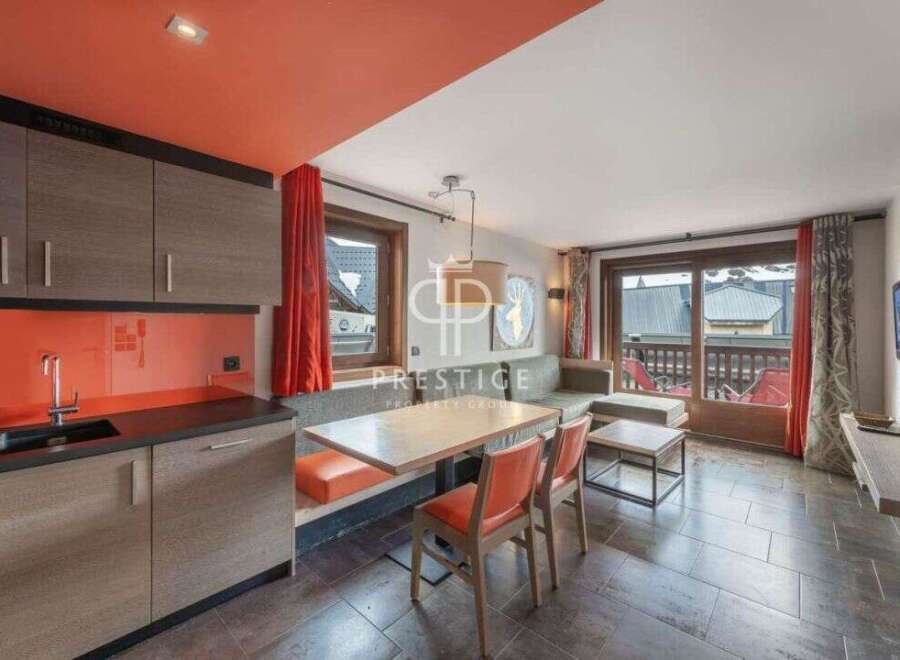 Discover a stylish apartment with a modern kitchen featuring sleek cabinetry and a vibrant backsplash.