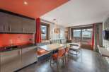 Discover a stylish apartment with a modern kitchen featuring sleek cabinetry and a vibrant backsplash.