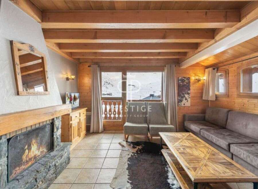 Experience the charm of this cozy chalet, featuring a stunning stone fireplace and warm wooden accents throughout.