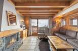 Experience the charm of this cozy chalet, featuring a stunning stone fireplace and warm wooden accents throughout.