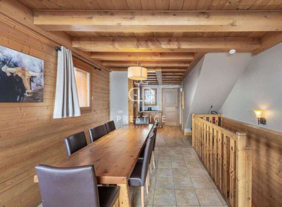This stunning property boasts a warm and inviting interior with beautiful wooden accents throughout.