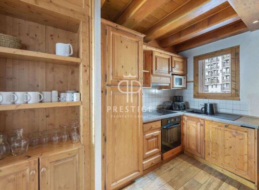 Discover the charm of this cozy kitchen, featuring warm wooden cabinetry and a rustic aesthetic.