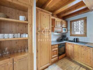 Discover the charm of this cozy kitchen, featuring warm wooden cabinetry and a rustic aesthetic.