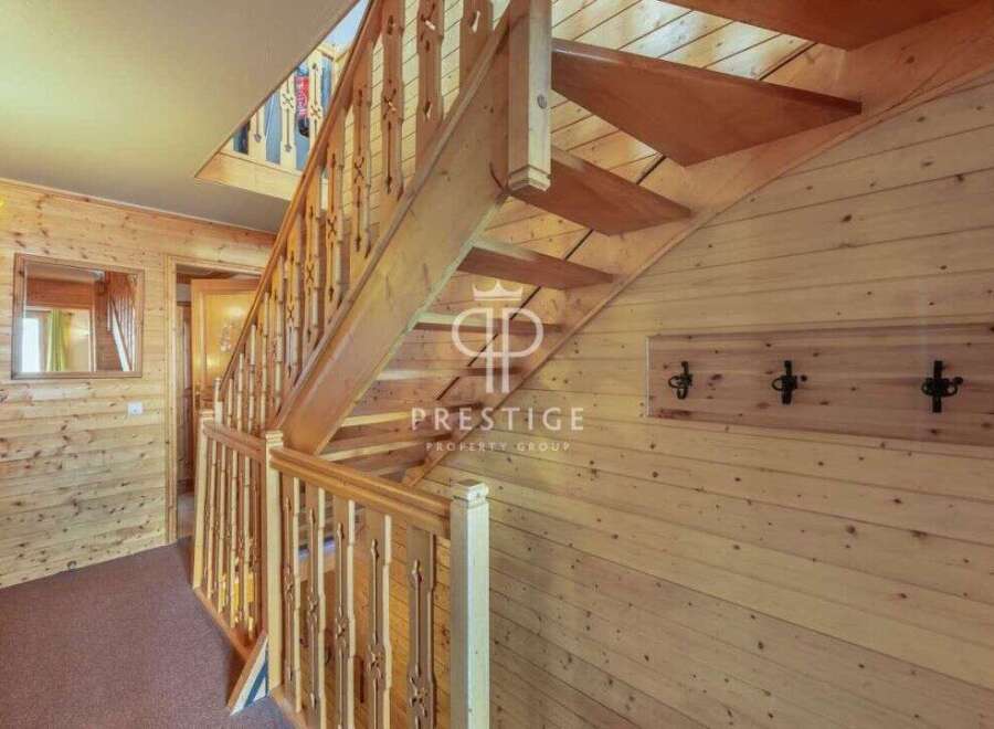 Discover the charm of this property, featuring a beautifully crafted wooden staircase that adds warmth and character.