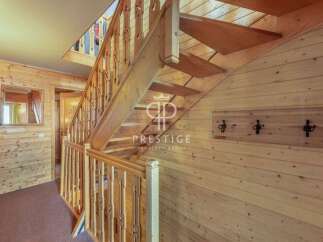 Discover the charm of this property, featuring a beautifully crafted wooden staircase that adds warmth and character.