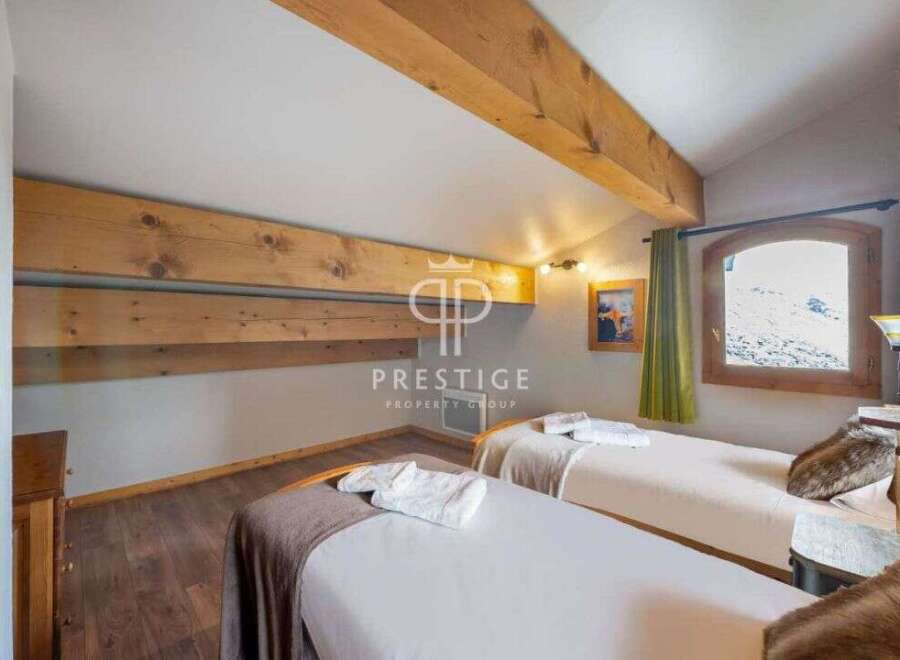 Discover the charm of this cozy bedroom, featuring two comfortable beds perfect for a relaxing stay.