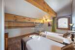 Discover the charm of this cozy bedroom, featuring two comfortable beds perfect for a relaxing stay.