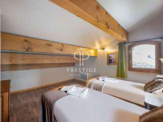 Discover the charm of this cozy bedroom, featuring two comfortable beds perfect for a relaxing stay.