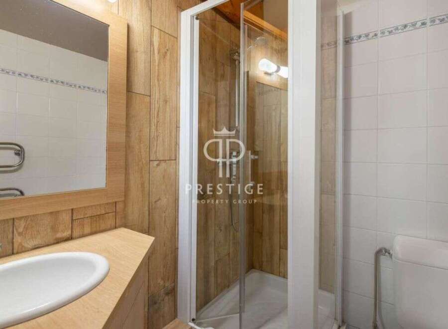 Discover a modern bathroom with a sleek shower enclosure.