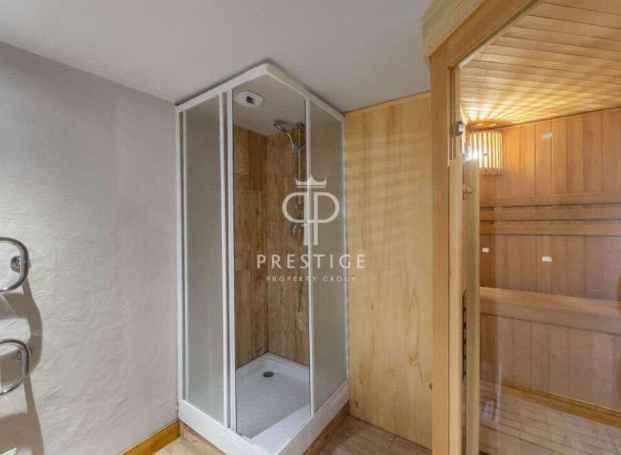 Discover luxury living with this stunning property featuring a modern shower and a relaxing sauna.