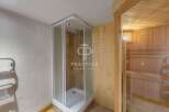 Discover luxury living with this stunning property featuring a modern shower and a relaxing sauna.