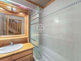 Discover a charming bathroom with a rustic wooden vanity and a sleek white sink.