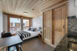 Cozy studio apartment with a rustic wooden interior.