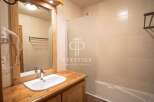 Discover a charming bathroom featuring a stylish vanity and a convenient hair dryer.