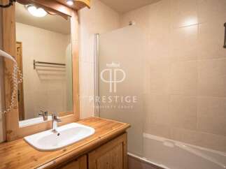 Discover a charming bathroom featuring a stylish vanity and a convenient hair dryer.