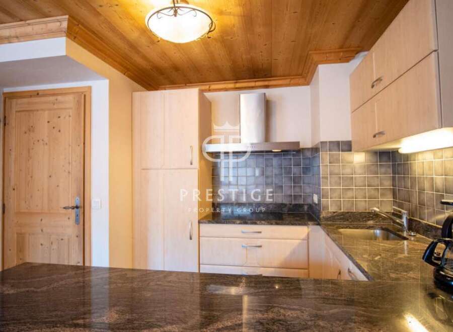 Discover a stunning kitchen with wooden cabinets and a sleek granite countertop.