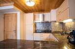 Discover a stunning kitchen with wooden cabinets and a sleek granite countertop.