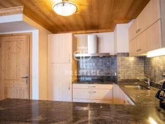 Discover a stunning kitchen with wooden cabinets and a sleek granite countertop.
