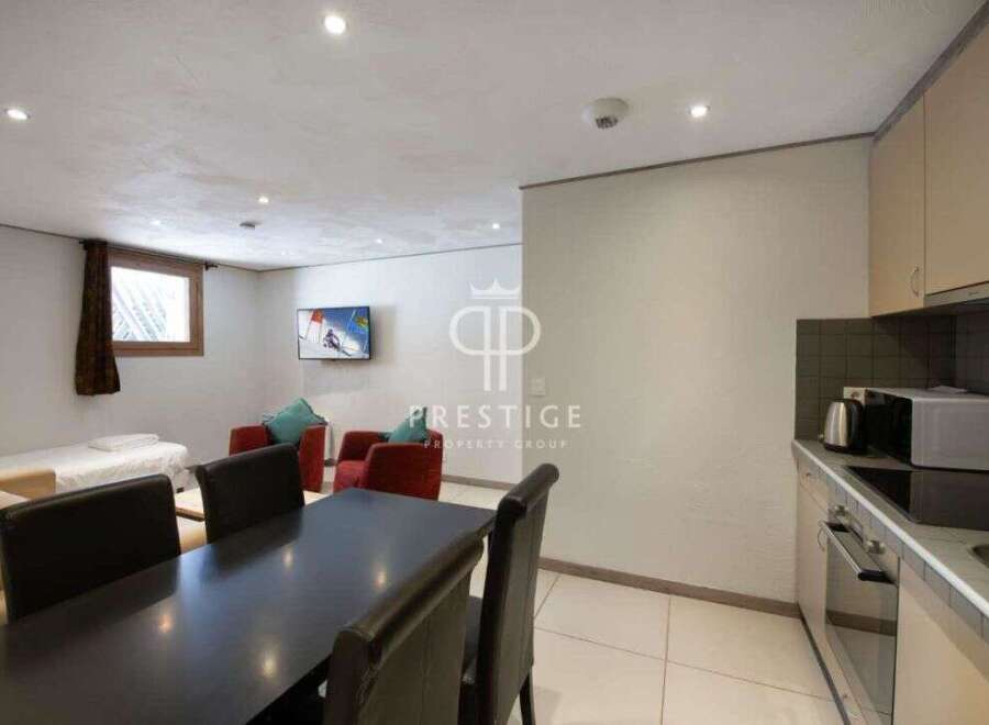 Discover a cozy living space with a modern kitchen and dining area.