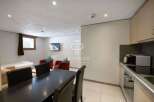 Discover a cozy living space with a modern kitchen and dining area.