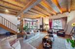 Experience the charm of this stunning property, featuring a cozy living room with a fireplace and exposed wooden beams.
