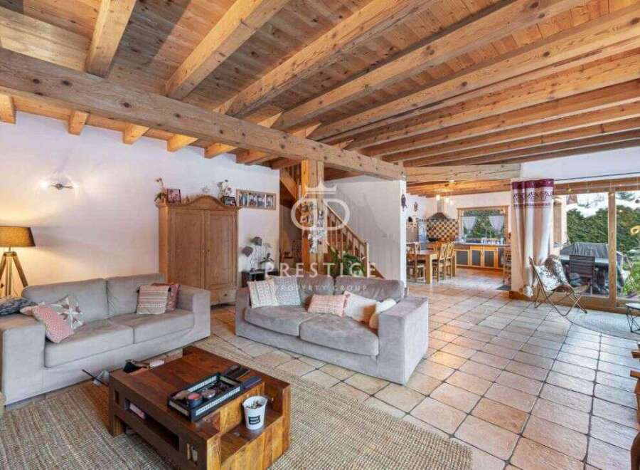 Discover the charm of this stunning property, featuring a warm and inviting living space with exposed wooden beams.
