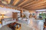 Discover the charm of this stunning property, featuring a warm and inviting living space with exposed wooden beams.