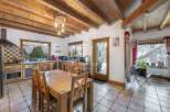 This charming kitchen boasts a rustic design with exposed wooden beams and a cozy dining area.