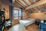 Cozy bedroom with wooden accents and a charming ambiance.