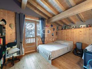 Cozy bedroom with wooden accents and a charming ambiance.