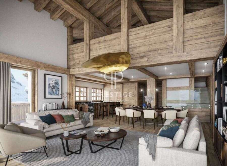 Experience luxury living in this stunning chalet, boasting a warm and inviting interior with exposed wooden beams and a cozy fireplace.