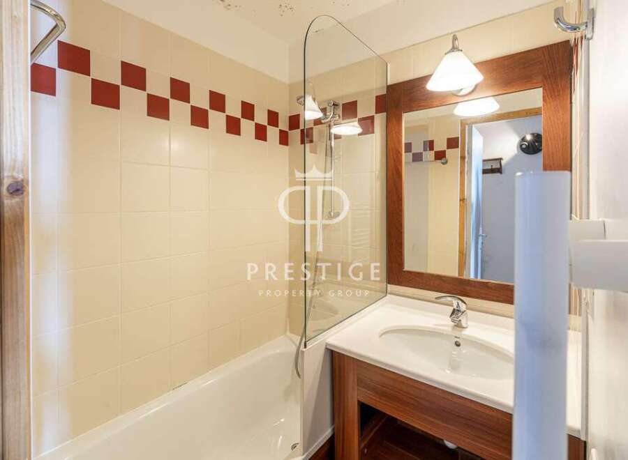 Discover a stylish bathroom featuring a sleek glass shower enclosure and a modern vanity.
